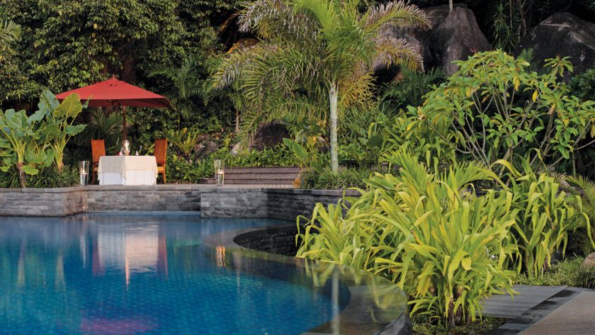 Dining by the main pool at Anantara Maia Seychelles Villas, Mahé | Just Seychelles