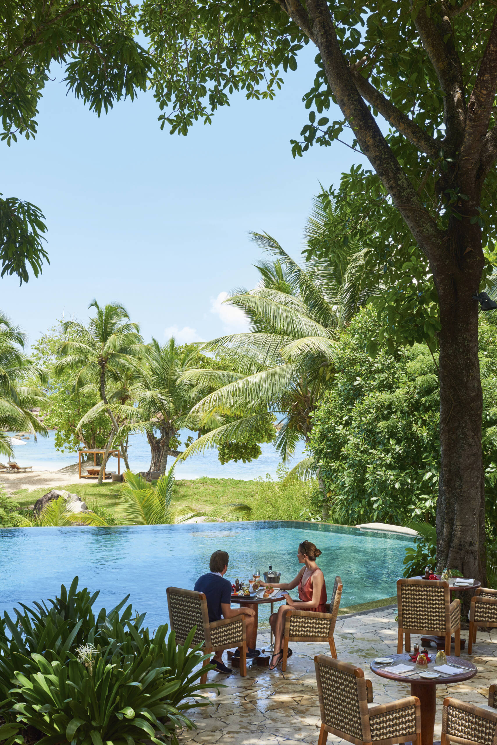 Dining by the main pool at Constance Lemuria, Praslin | Just Seychelles