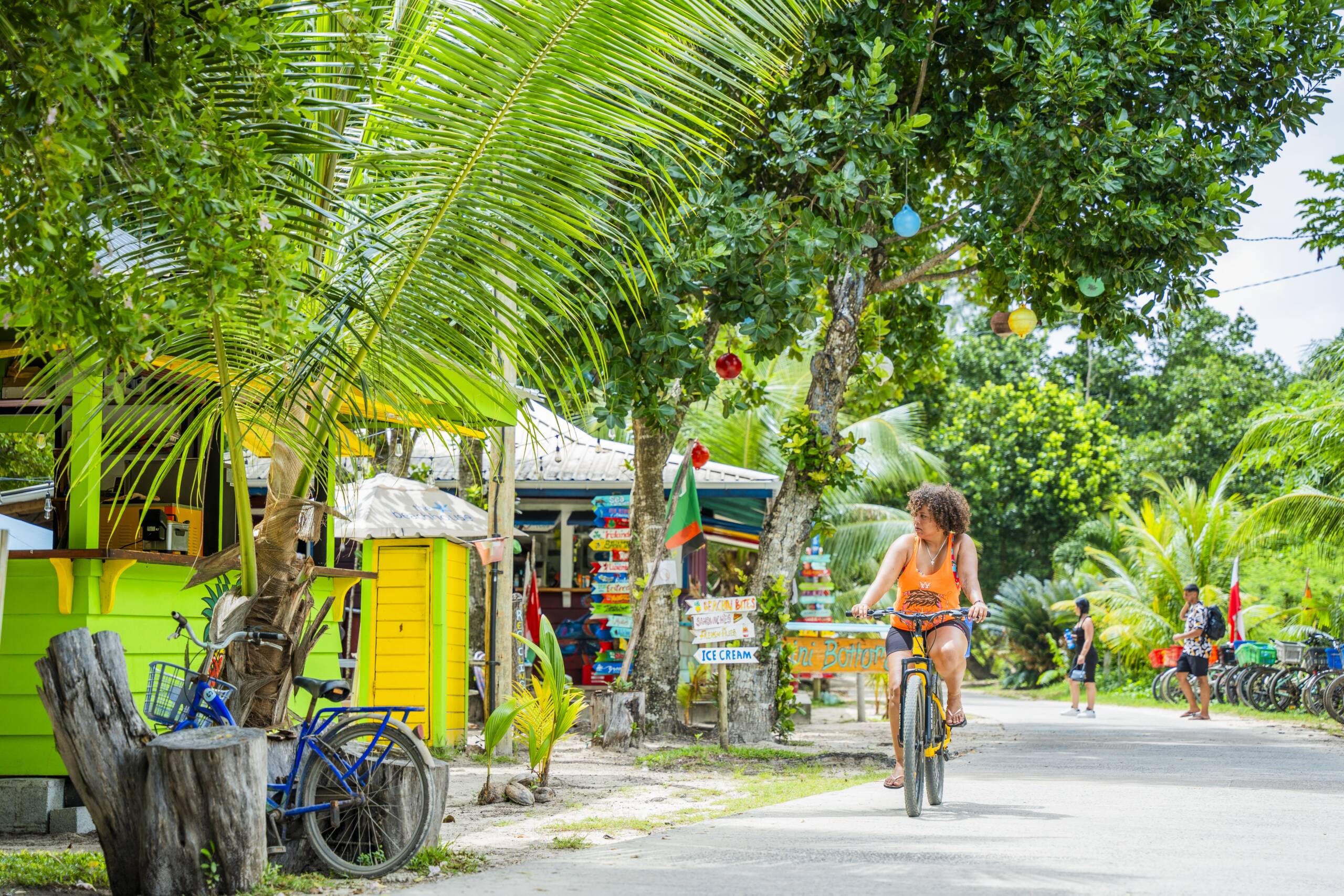 Woman cycling through La Digue | Just Seychelles
