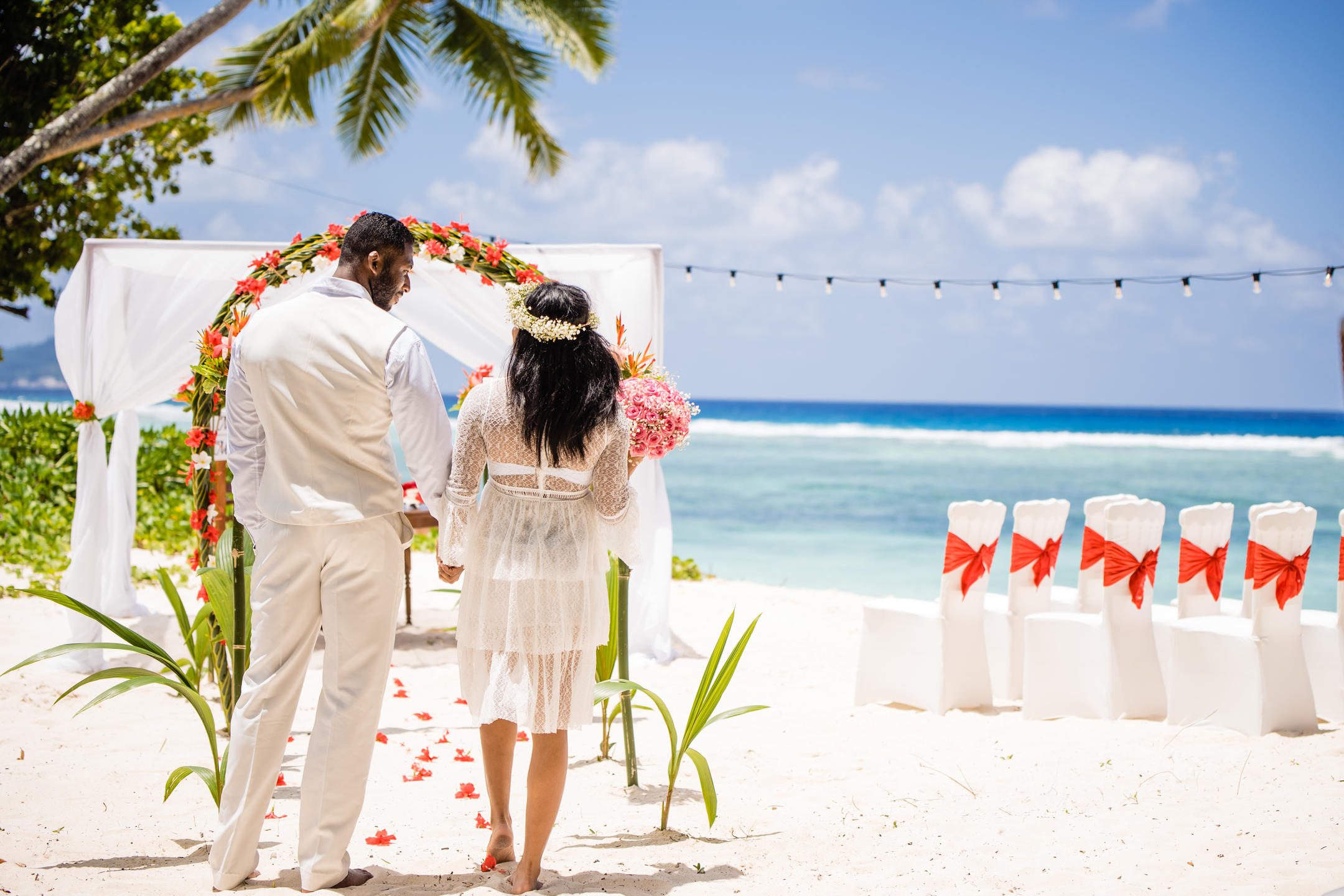 Couple getting married on the beach at Niva Labriz Seychelles | Just Seychelles