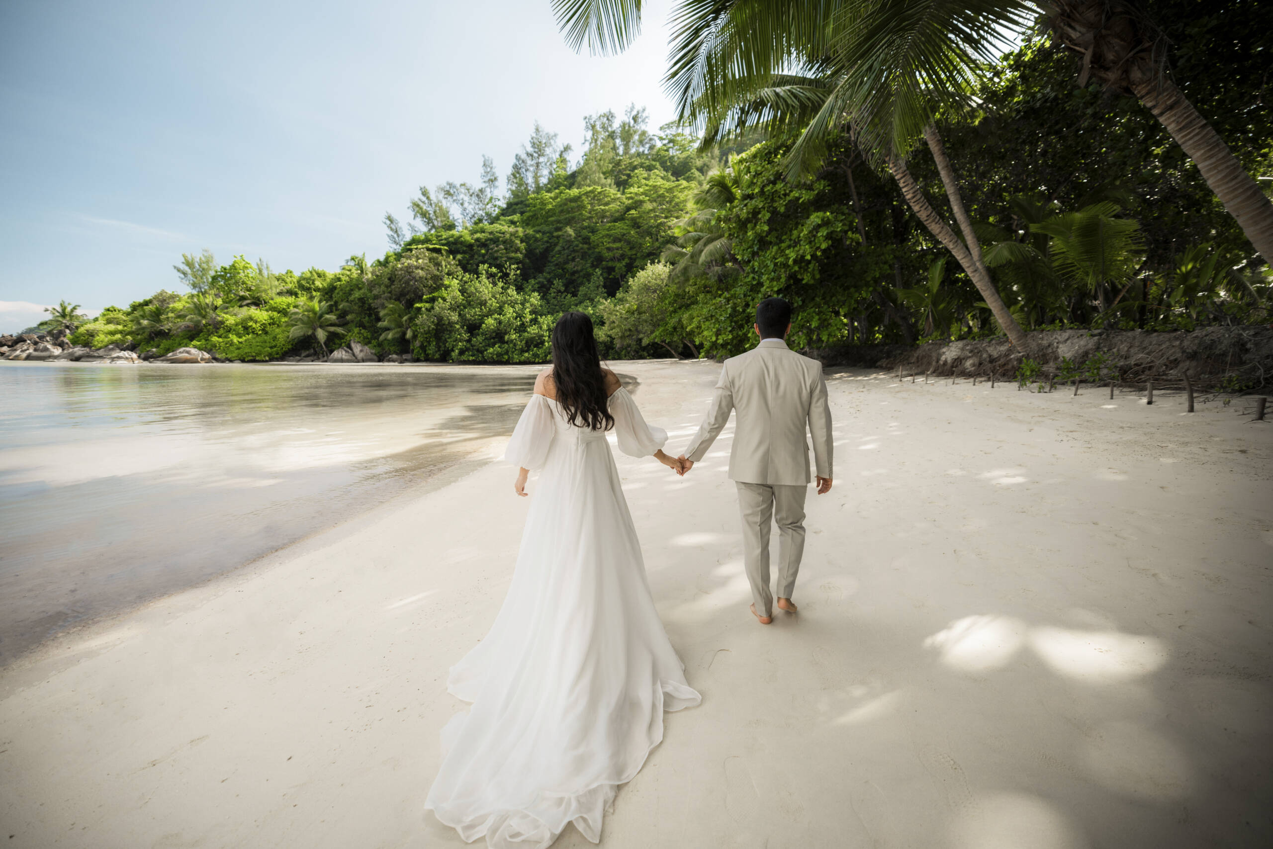 Bride and groom on the beach at Constance Ephelia | Just Seychelles