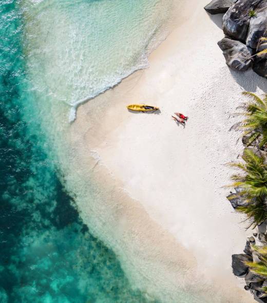 Aerial view of couple on the beach at Enchanted Island Resort | Just Seychelles