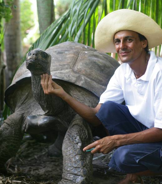 Staff at Denis Island with giant tortoise | Just Seychelles