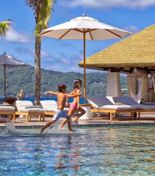Children enjoying the main pool at Six Senses Zil Pasyon | Just Seychelles
