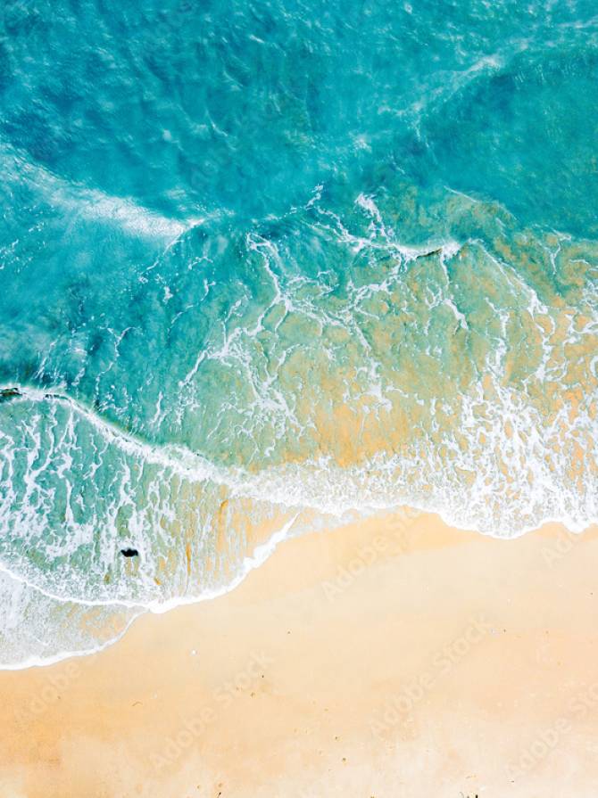 Top view of blue aqua sea water. Capture by drone. Capture sea wave and beach in summer by drone.